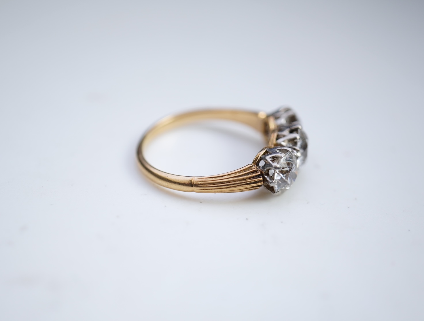 An attractive three-stone diamond ring, early 20th century